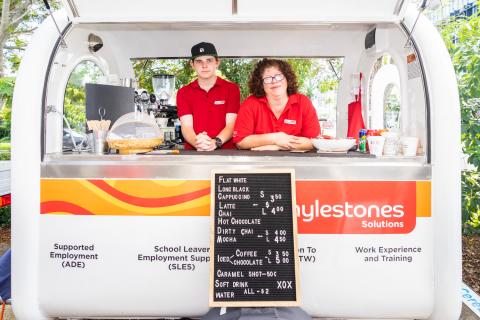 Lachlan and Adelaide standing inside the Mylestones Solutions Coffee Cart